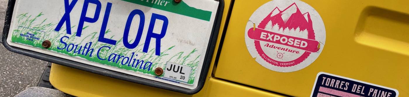 bumper of yellow vehicle featuring South Carolina license plate and bumper stickers